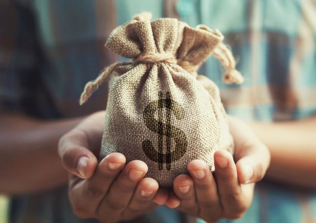 woman hand holding money bag. concept saving finance and accounting