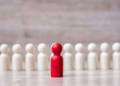 red leader businessman with crowd of wooden men. leadership, business, team, teamwork and Human resource management concept